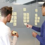 Twee mensen plannen een contentstrategie met sticky notes